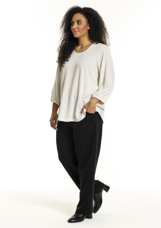 Studio-stribet bluse og sorte bukser i plussize, perfekt til både afslappet og kontorbrug.
